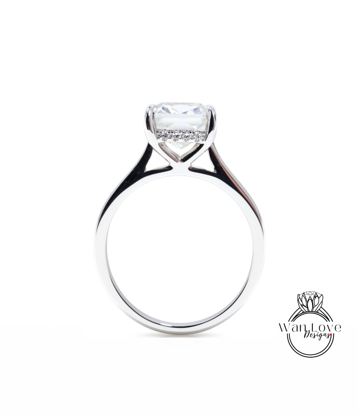 A silver engagement ring with a large, clear gemstone set in the center of the band.