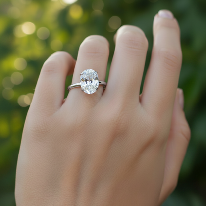 A close-up of a person's hand wearing a diamond engagement ring.
