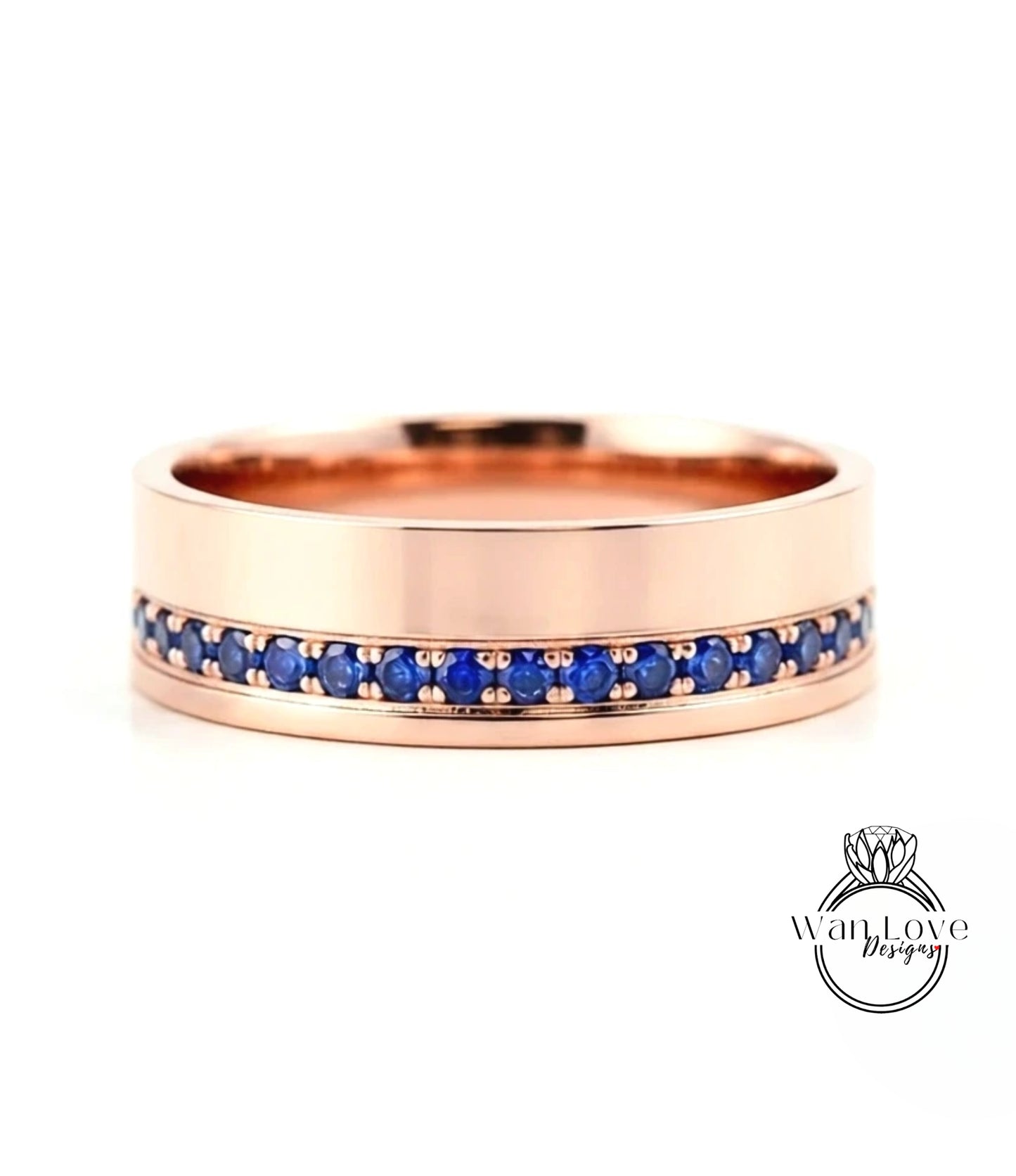 A rose gold ring with a row of blue sapphires set in the band.