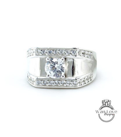 A silver ring with a large central diamond surrounded by smaller diamonds along the band.