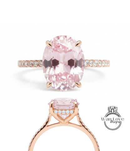 A beautiful pink gemstone engagement ring with a gold band and small diamonds.