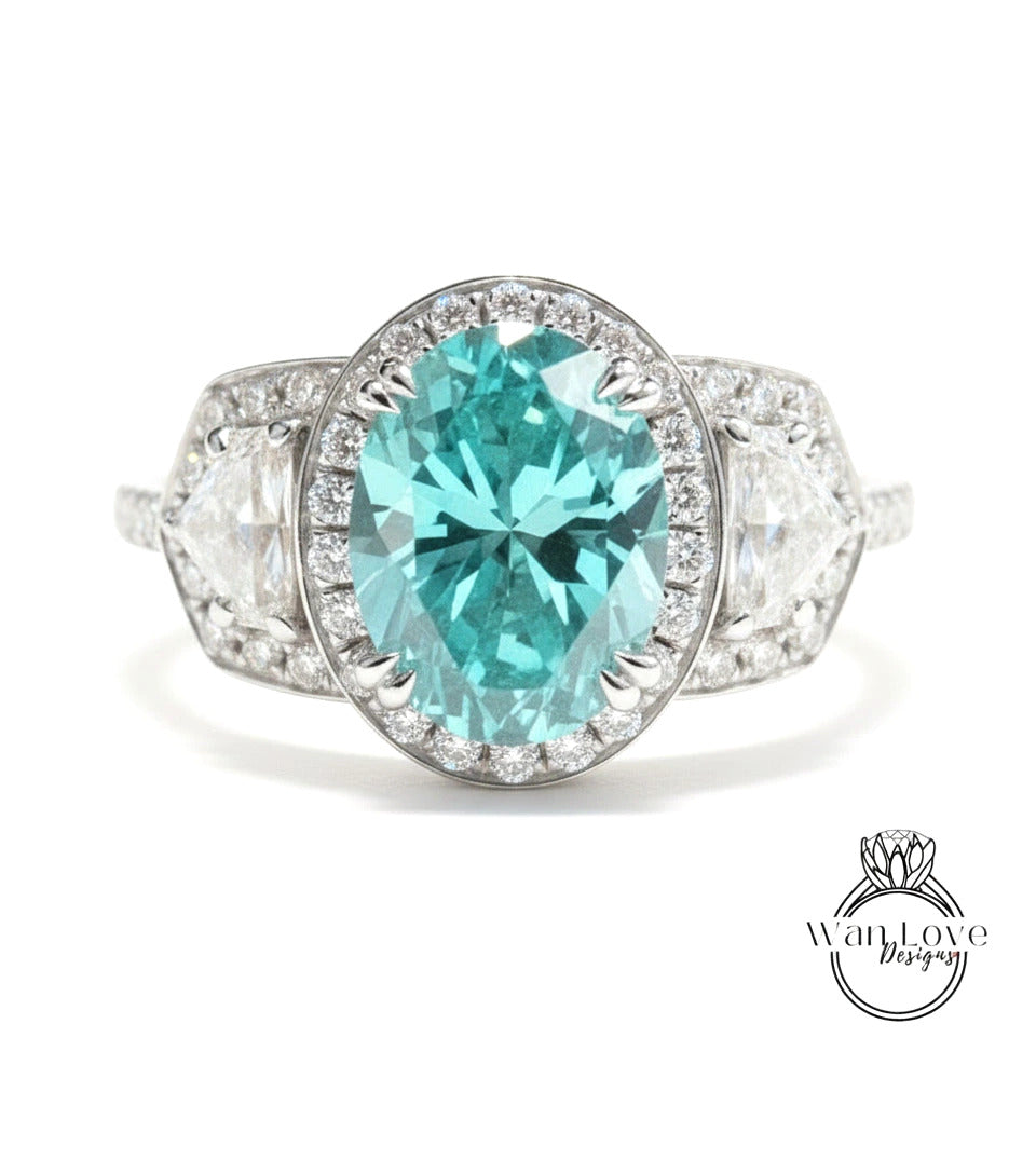A stunning engagement ring with a large oval-shaped blue gemstone surrounded by smaller diamonds, set in a silver band.