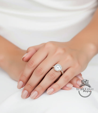 A close-up of a person's hand wearing a large diamond engagement ring.