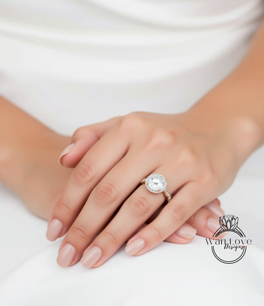 A close-up of a person's hand wearing a large diamond engagement ring.