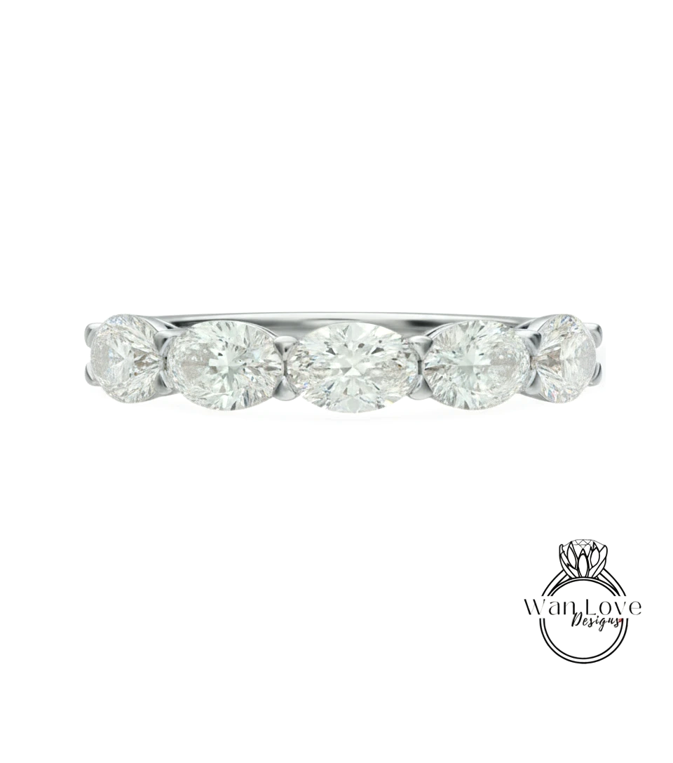 A diamond ring with a row of oval-shaped diamonds set in a silver band.