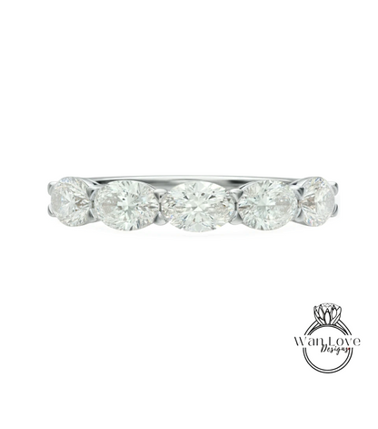 A diamond ring with a row of oval-shaped diamonds set in a silver band.