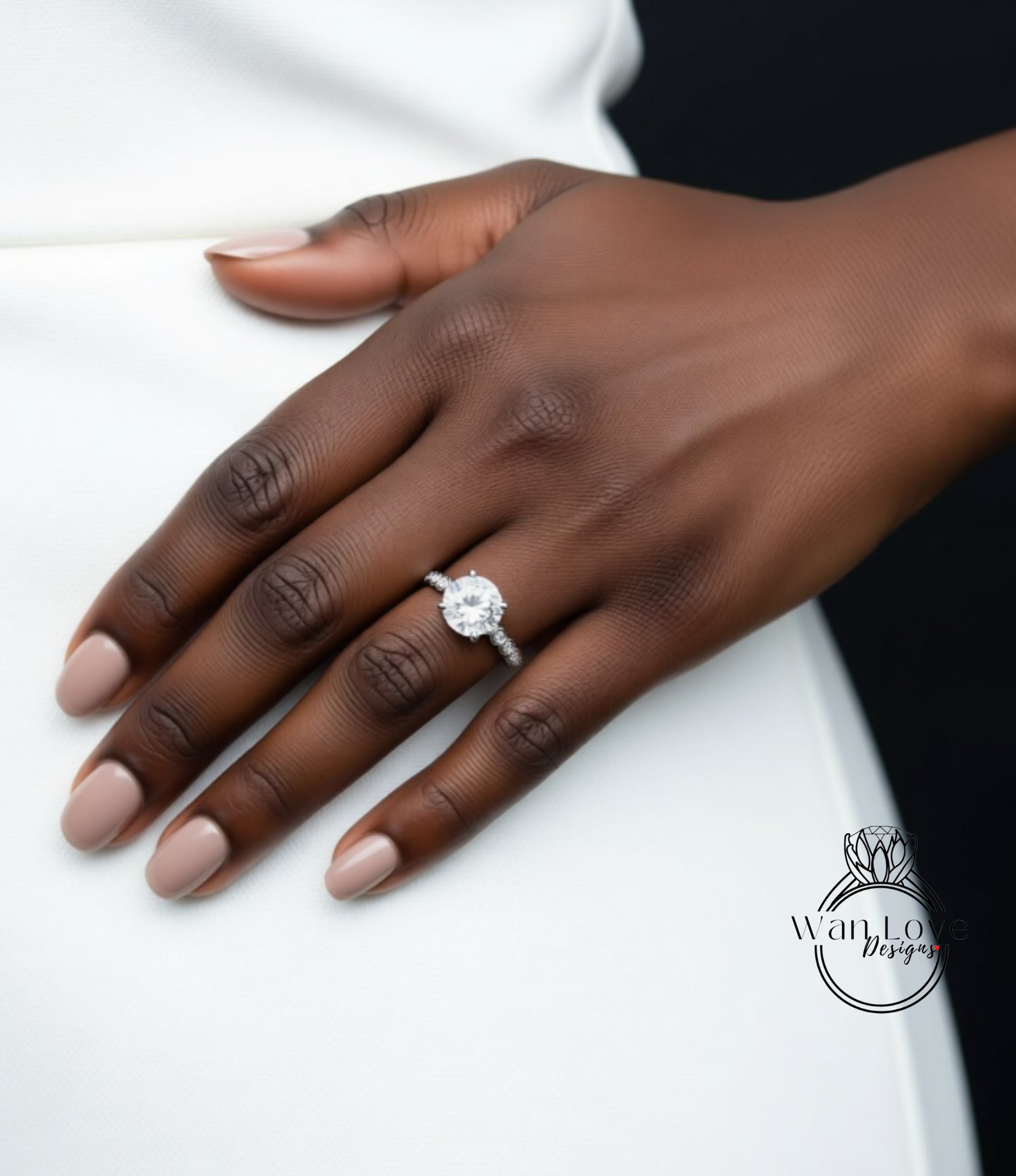 A close-up of a hand wearing a diamond engagement ring.
