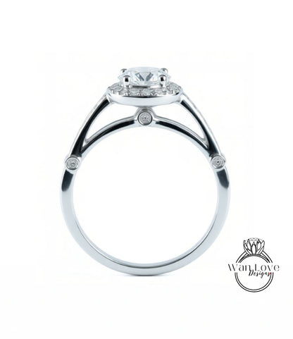 A silver engagement ring with a large central diamond and smaller diamonds around the halo.