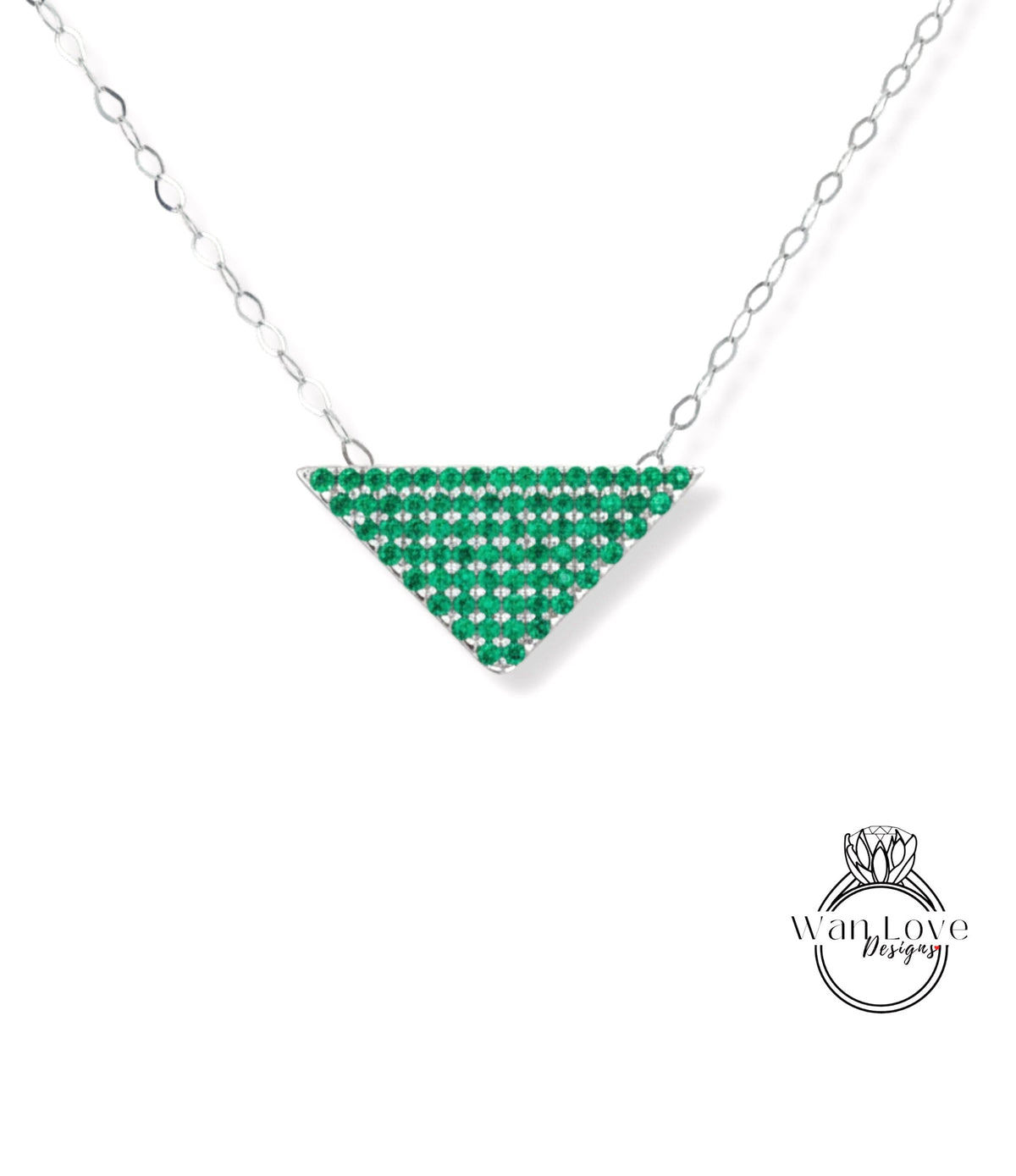 A necklace with a triangular pendant made of green gemstones, such as emeralds, set in a silver metal frame.