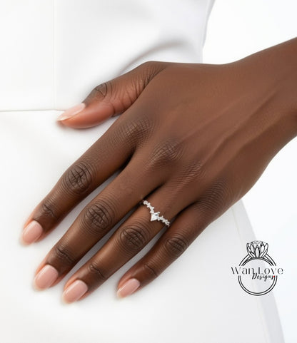 A close-up of a hand wearing a diamond engagement ring.
