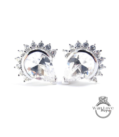 A pair of elegant earrings with large, clear gemstones set in a silver frame, creating a sparkling and sophisticated design.