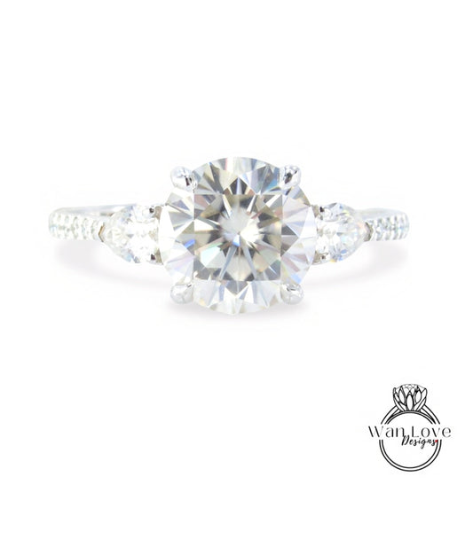A close-up view of a diamond engagement ring with a large round brilliant cut diamond set in a silver band.