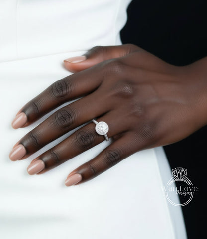 A close-up of a hand wearing a diamond engagement ring.
