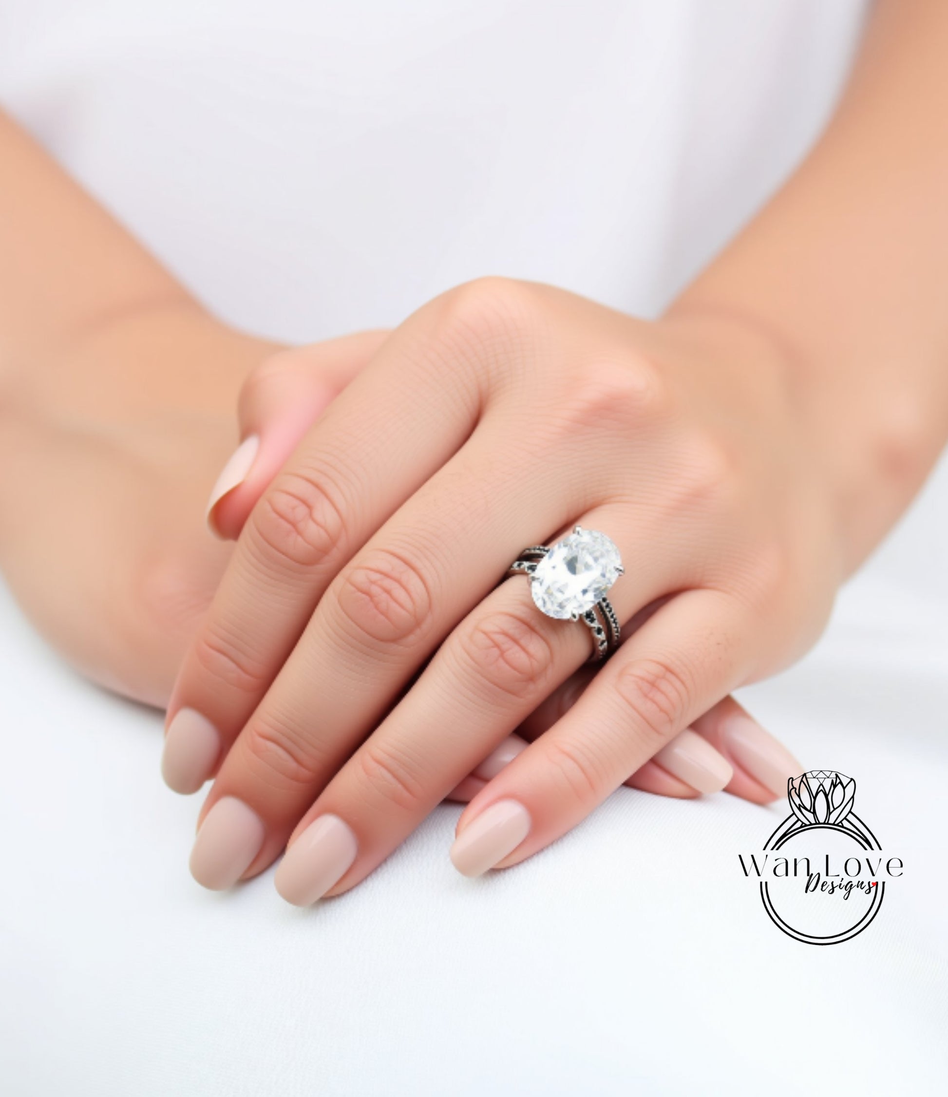 A close-up of a person's hand wearing a large diamond engagement ring.