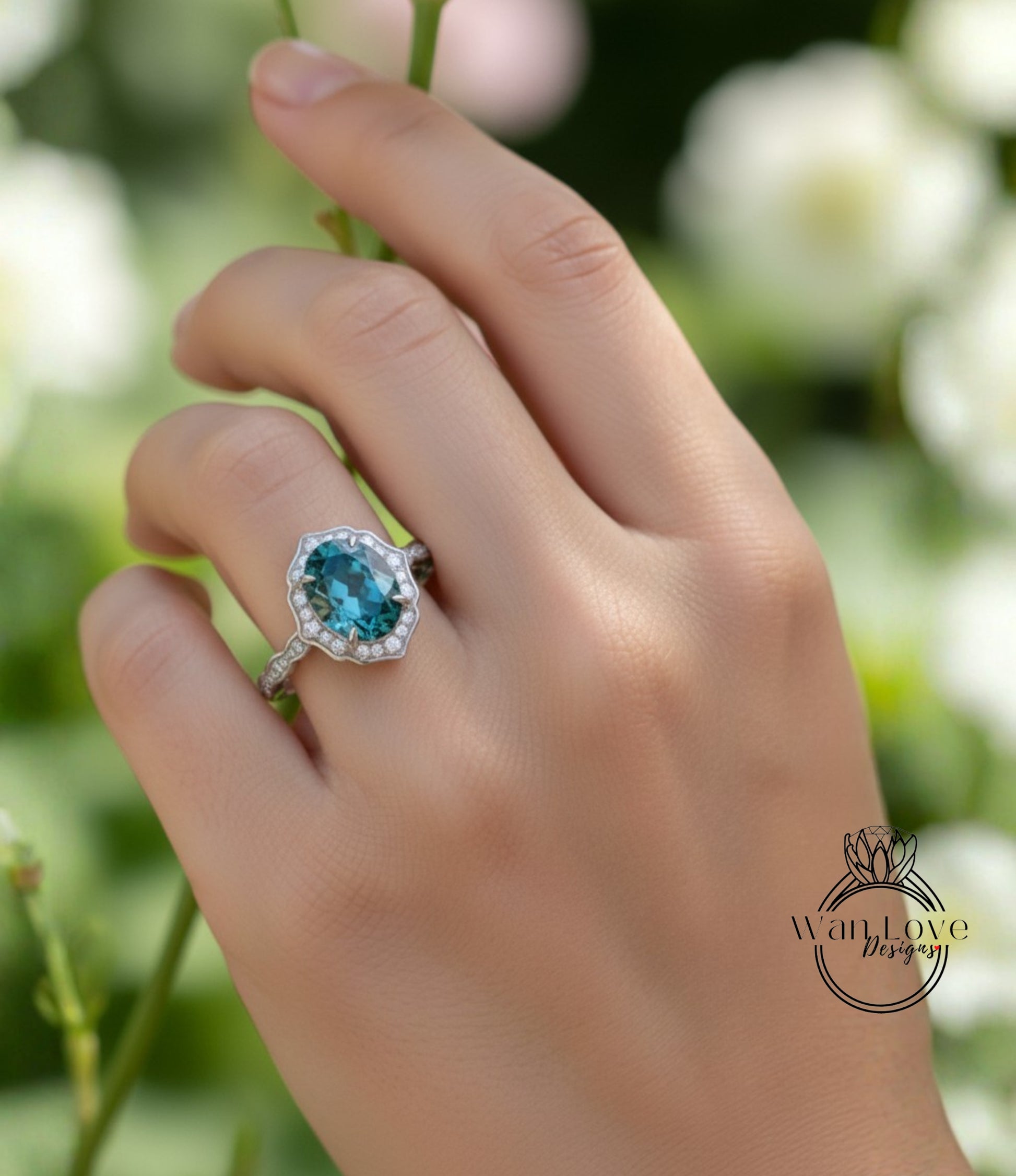 A close-up of a hand wearing a ring with a blue gemstone, set in a silver band.