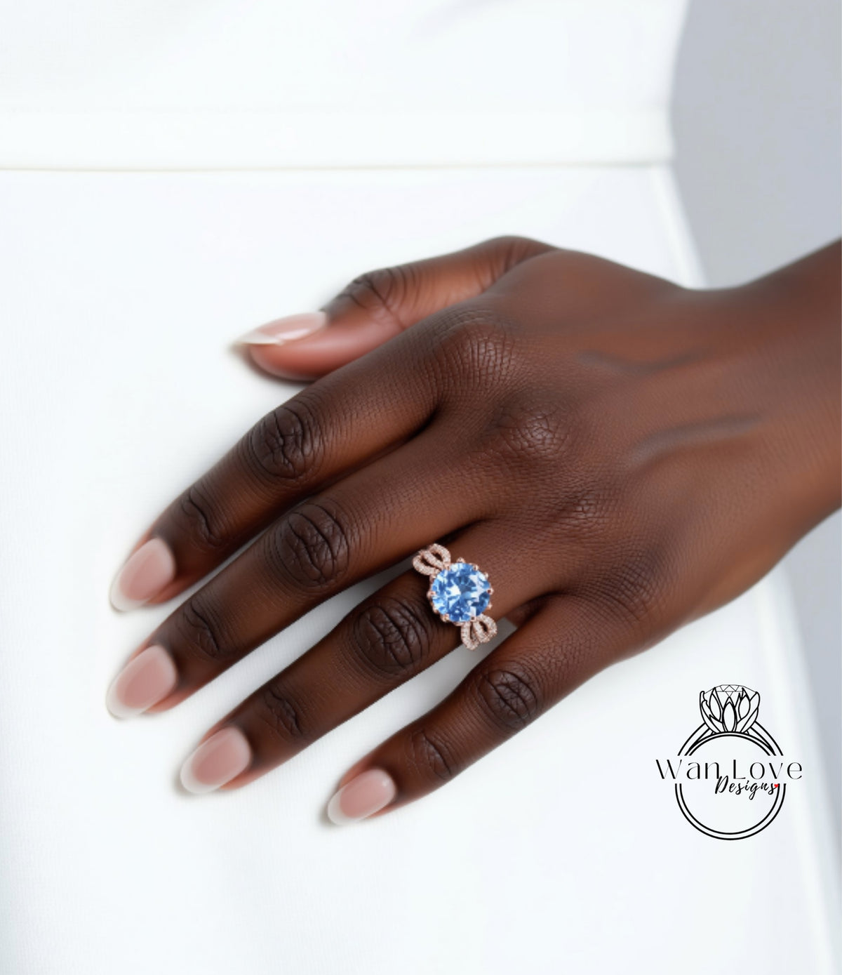 A close-up of a hand wearing a ring with a blue gemstone.