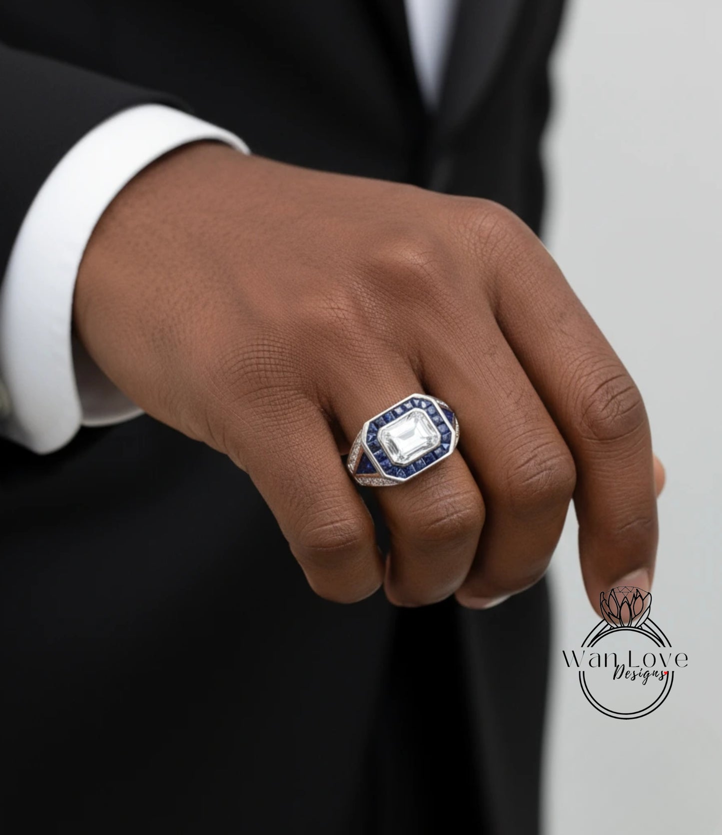 A close-up of a person's hand wearing a ring with a large blue gemstone.