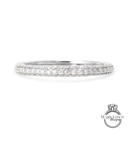 A diamond band ring with a row of small diamonds set in a silver band.