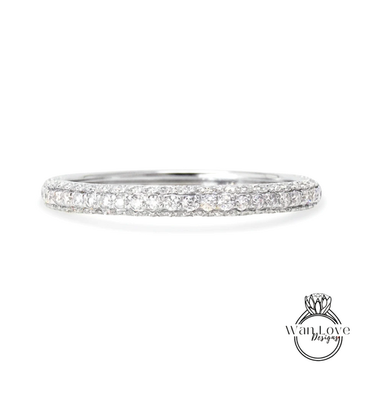 A diamond band ring with a row of small diamonds set in a silver band.