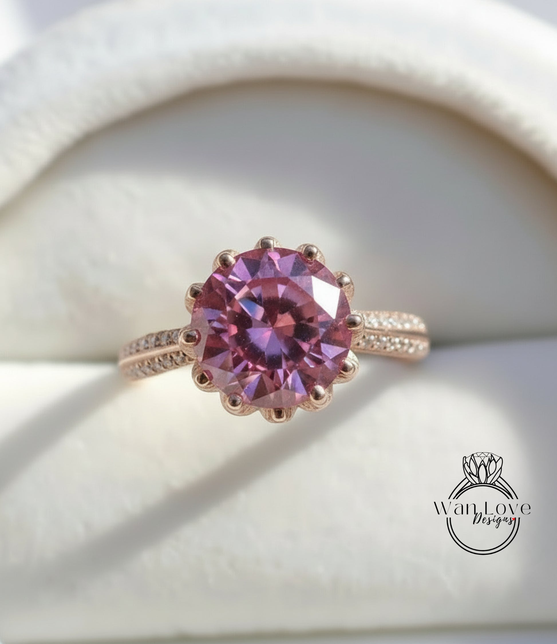 A close-up image of a pink gemstone ring with a large, round center stone surrounded by smaller stones.