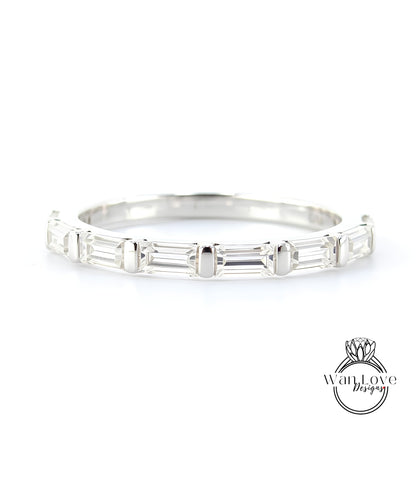 A silver band with a row of clear gemstones, likely diamonds, set in a simple yet elegant design.