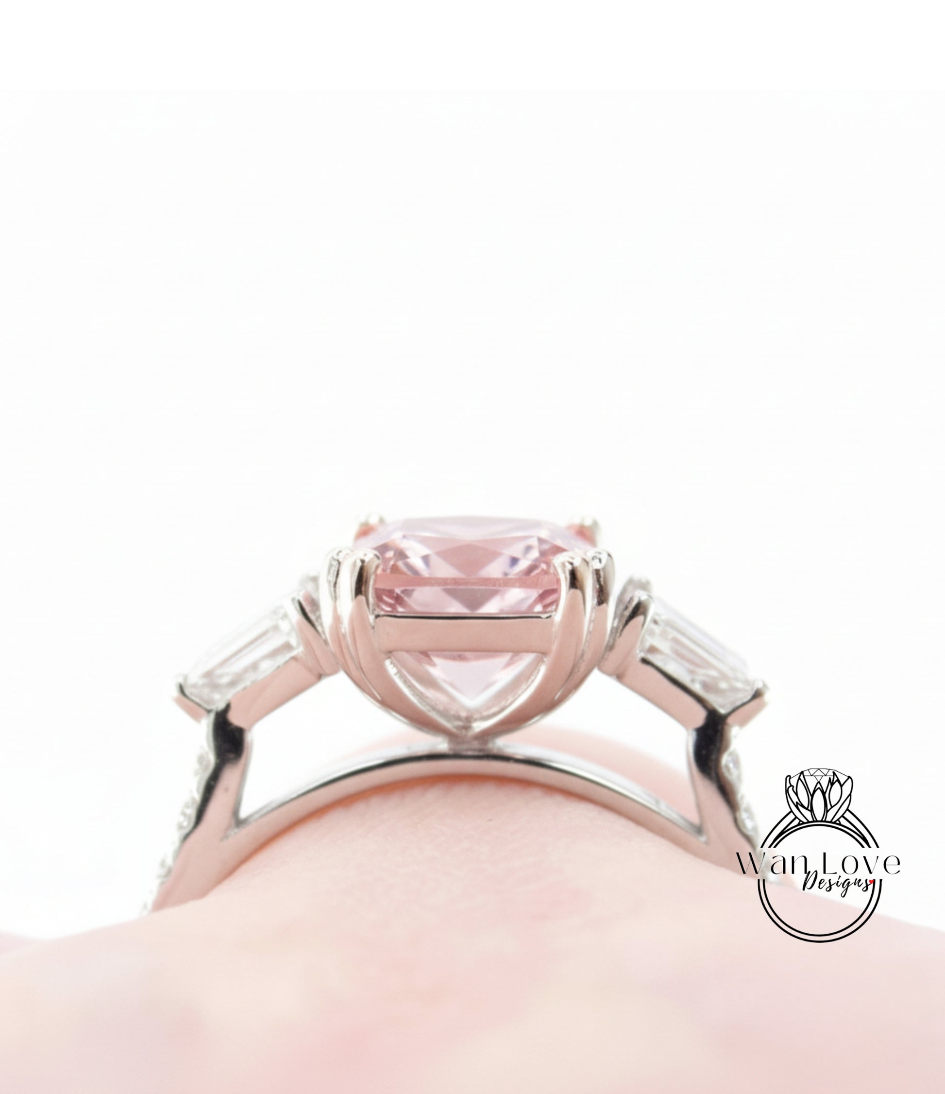 A close-up view of a silver ring with a large pink gemstone, showcasing the intricate design and craftsmanship.