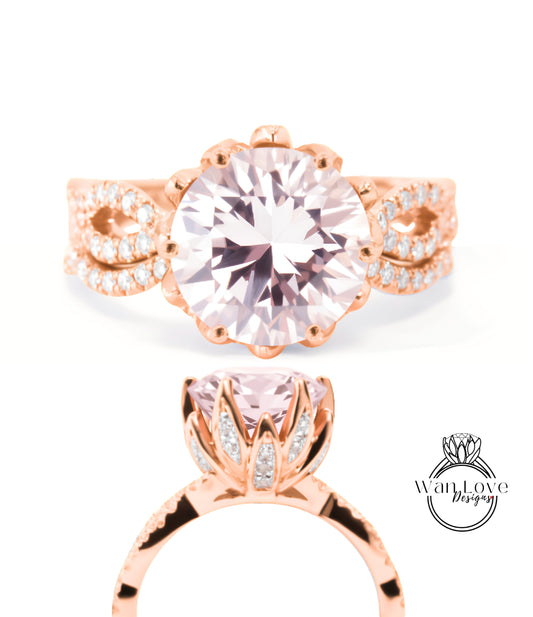 a beautiful pink gemstone ring with a large central gemstone surrounded by smaller diamonds. The ring is designed with a delicate floral motif and has a rose gold band.