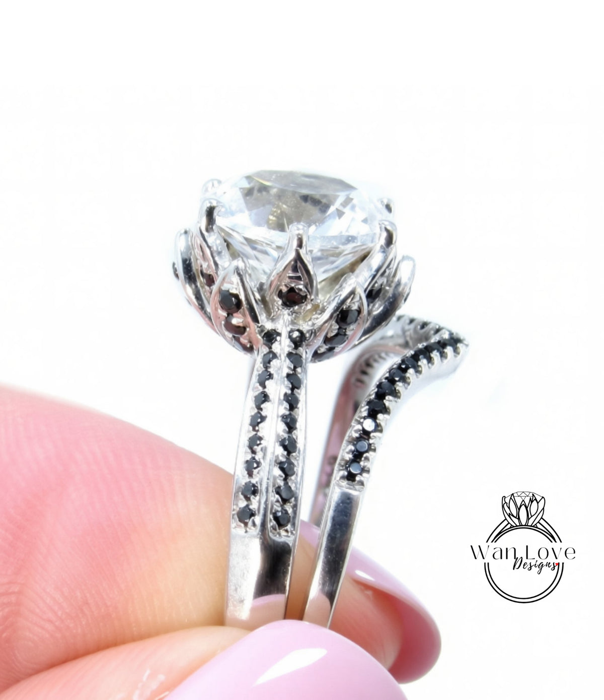 A close-up of a person's hand holding a silver ring with a large, clear gemstone.