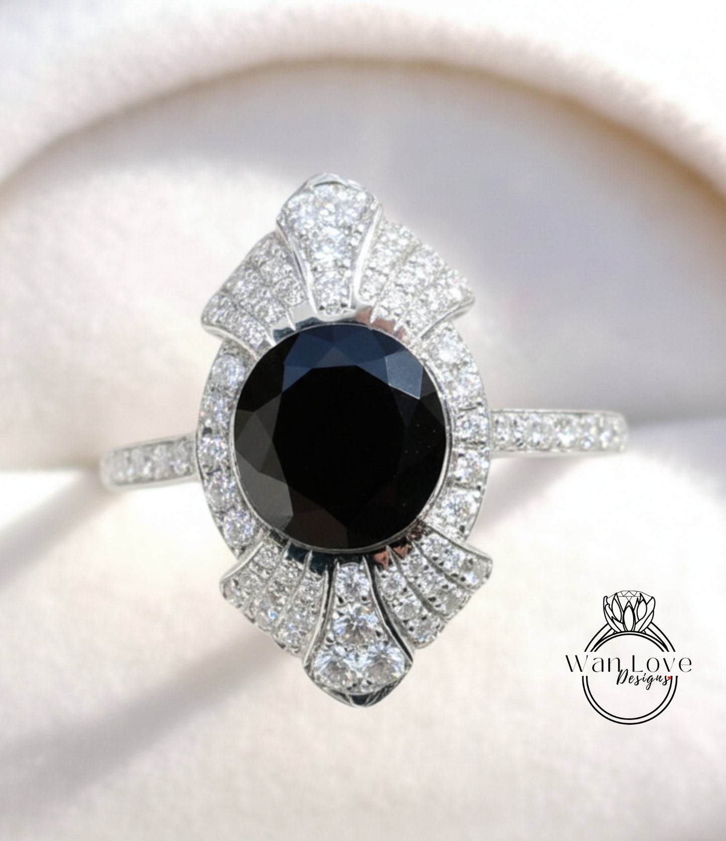 A close-up image of a diamond ring with a large black gemstone at the center, surrounded by smaller diamonds.