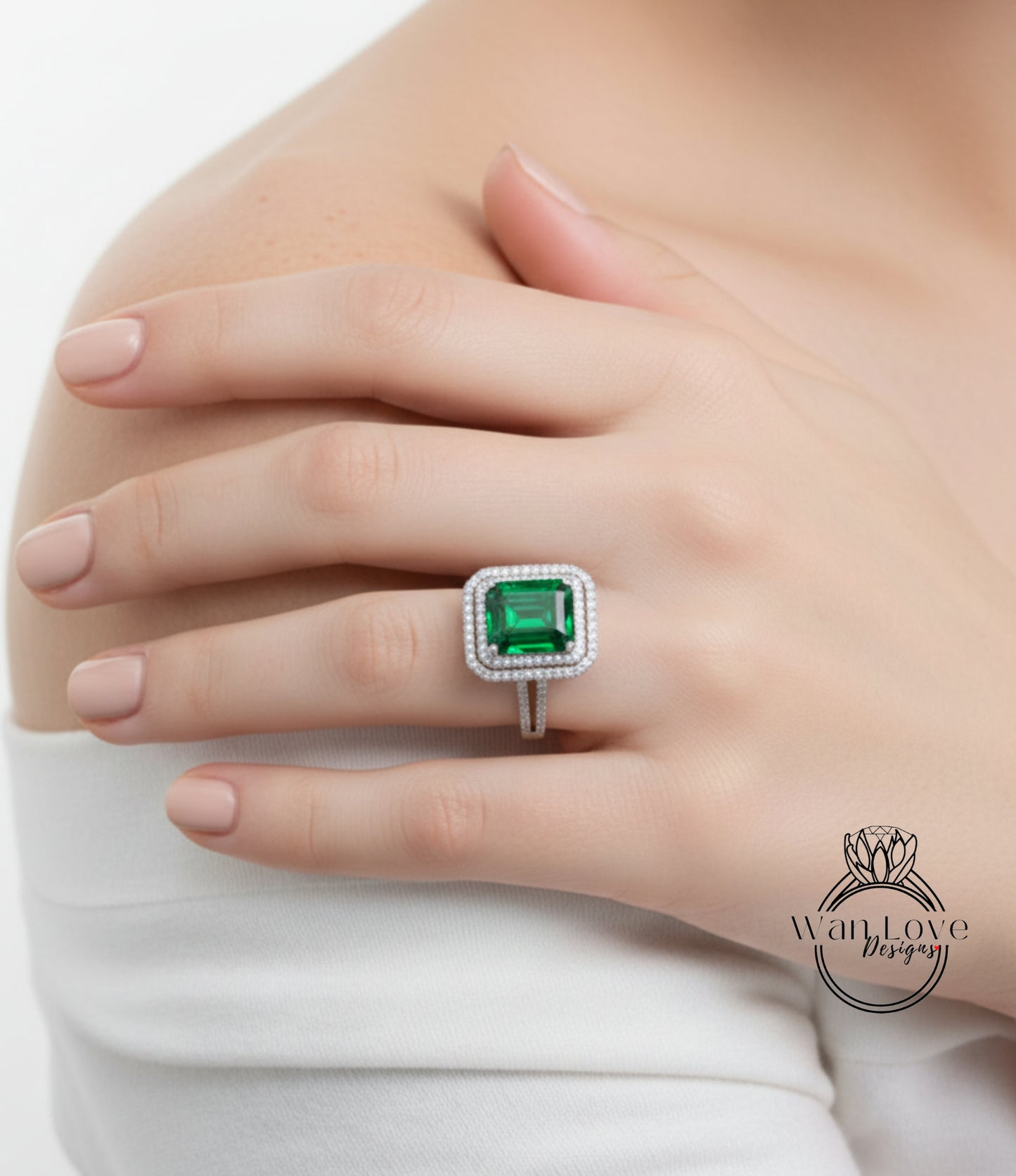 A close-up of a person's hand wearing a large, ornate ring with a green gemstone.