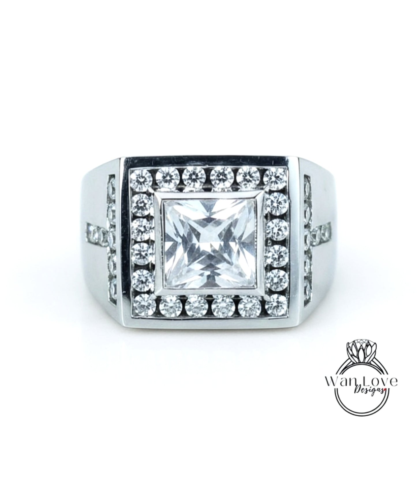 A silver ring with a large, square-cut diamond as the centerpiece, surrounded by smaller diamonds.