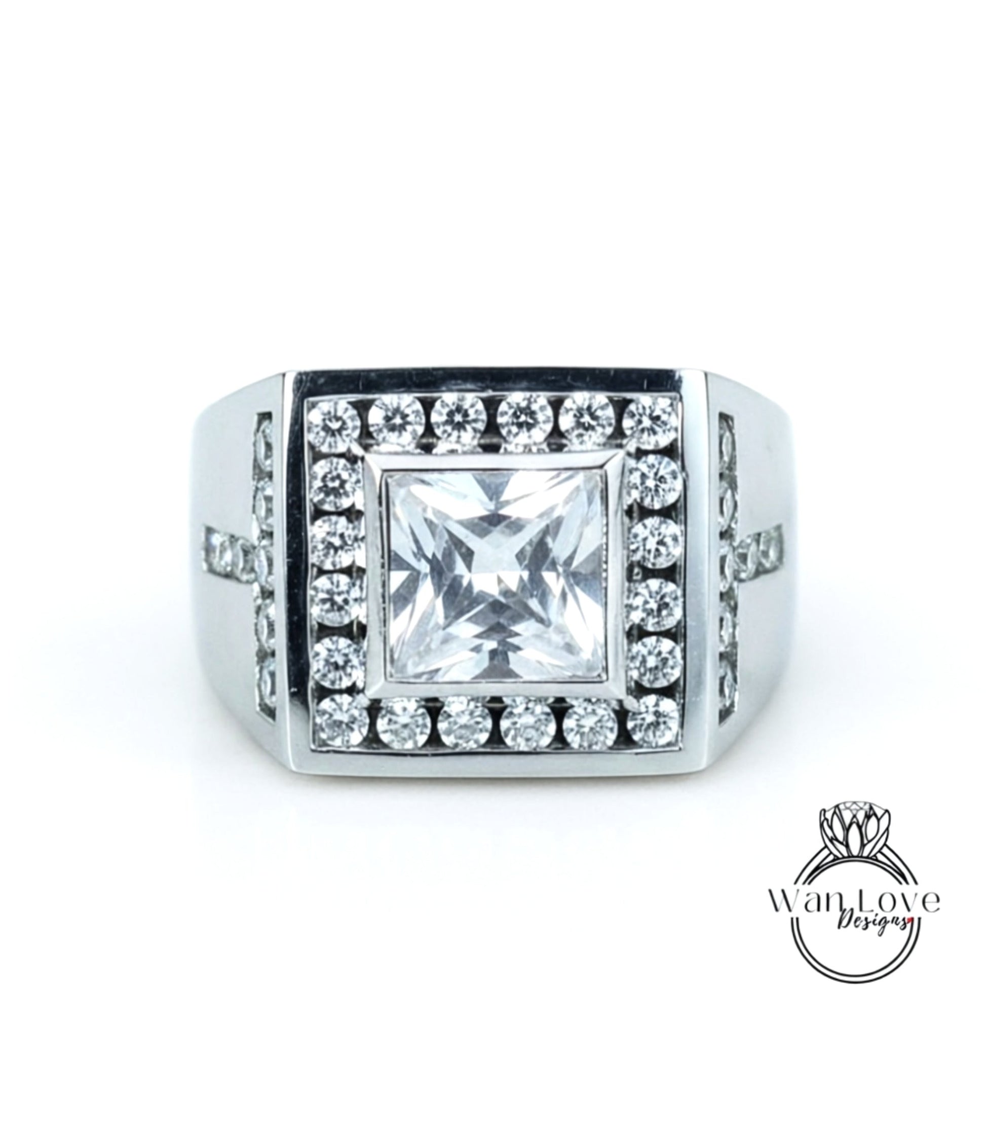 A silver ring with a large, square-cut diamond as the centerpiece, surrounded by smaller diamonds.