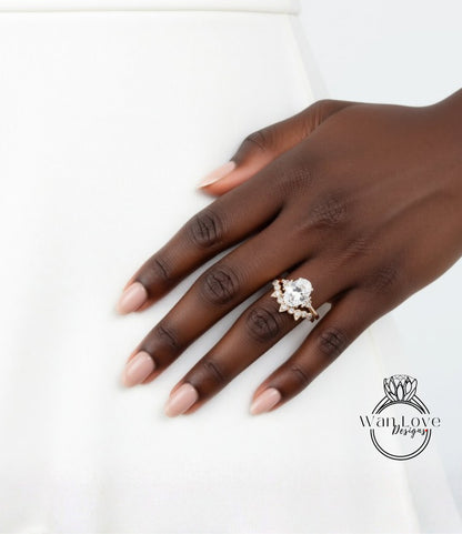 A close-up of a hand wearing a gold ring with a large diamond, resting on a white surface.
