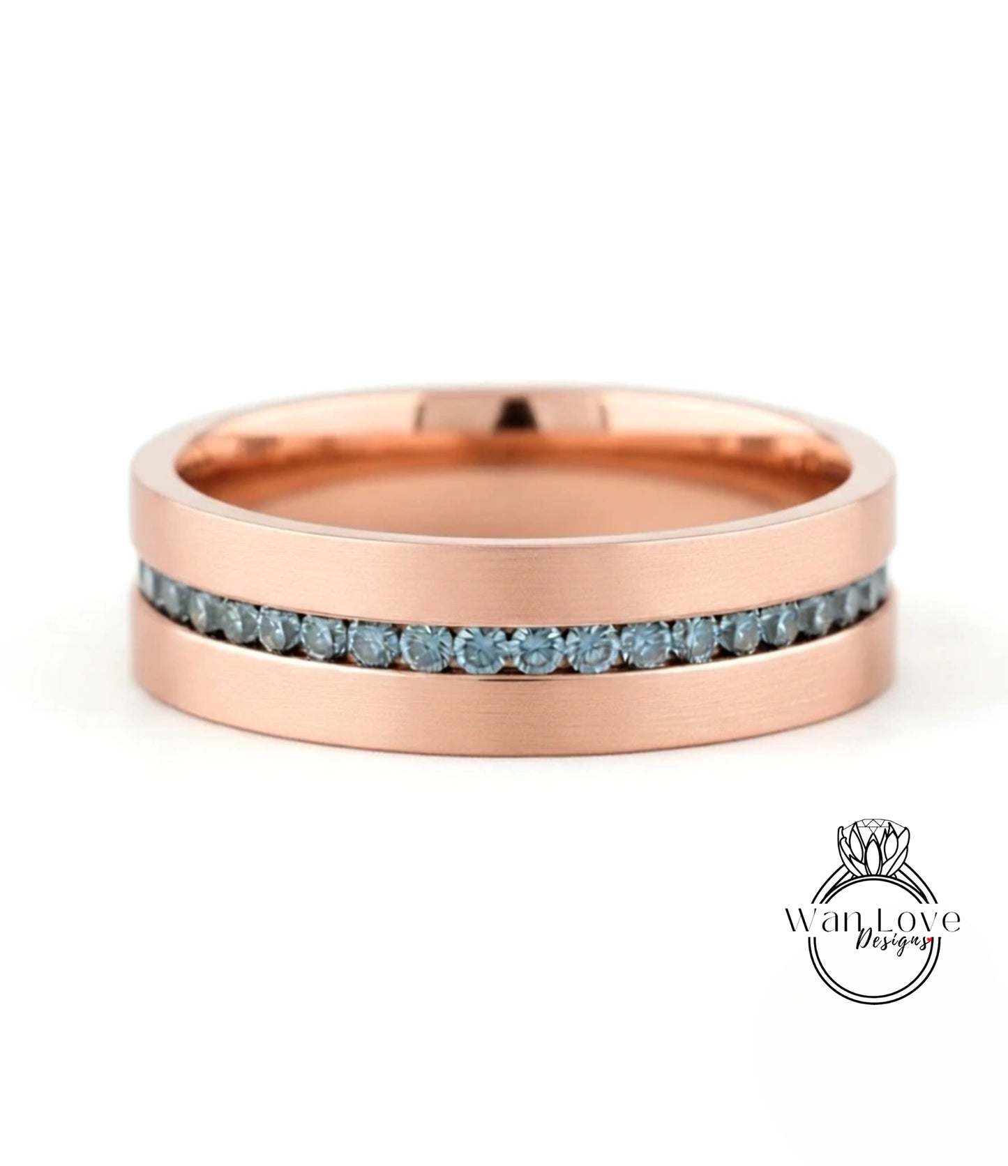 A rose gold band with a row of blue diamonds set in it.