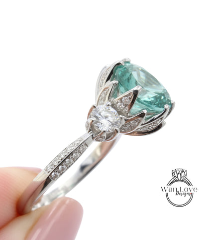 A close-up of a silver ring with a large, round gemstone, possibly a diamond, set in a decorative flower-like design.