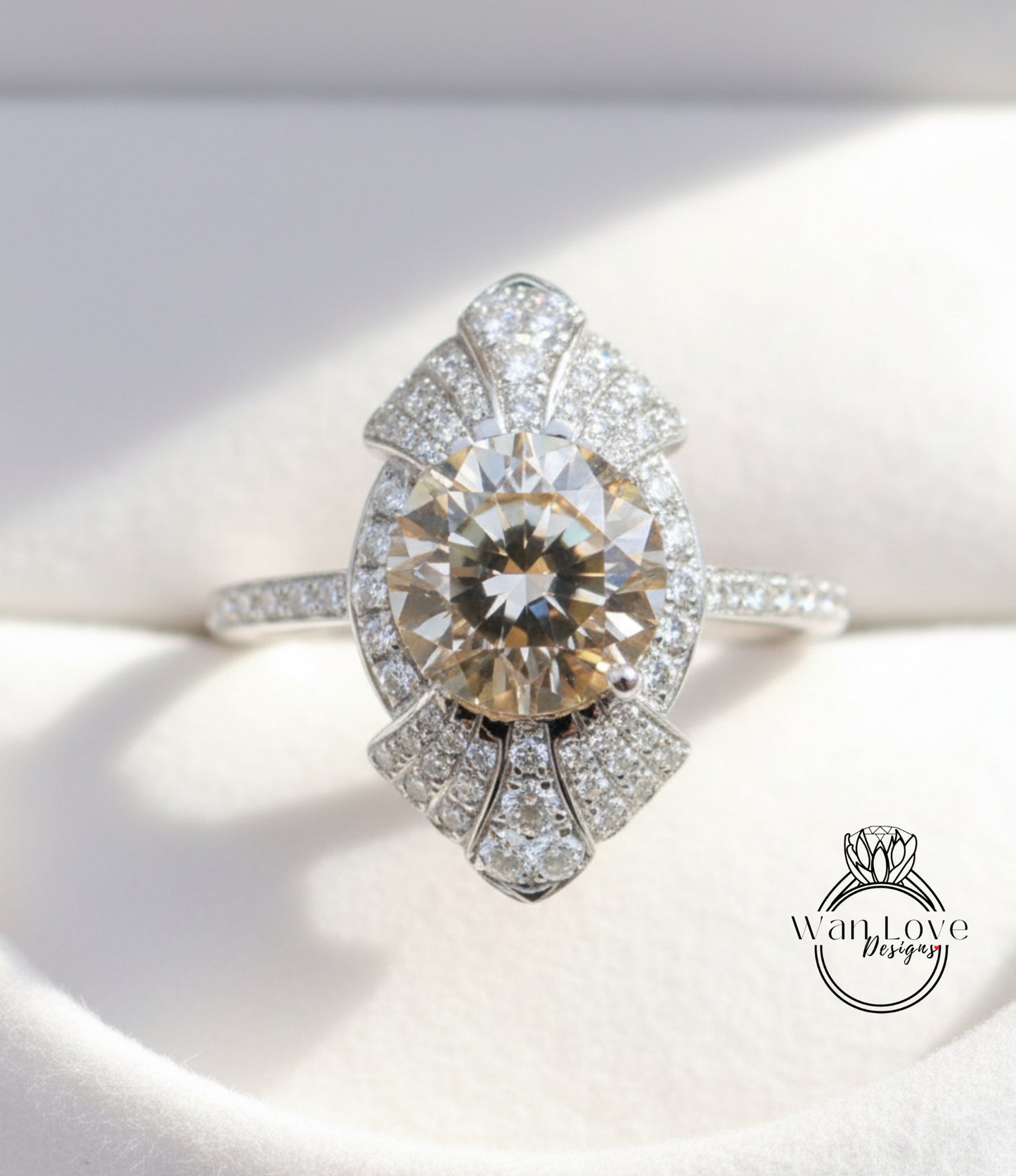 A close-up image of a diamond engagement ring with a large central diamond surrounded by smaller diamonds on either side, set in a silver band.