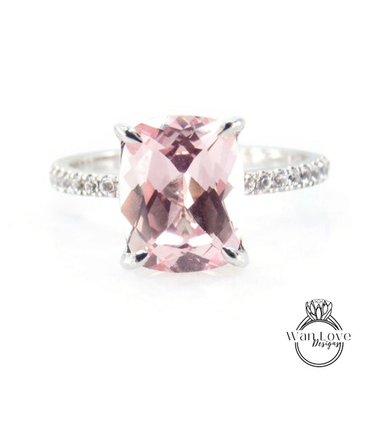 A ring with a large pink gemstone, likely a pink gemstone like a pink topaz or amethyst, set in a silver band with small diamonds.