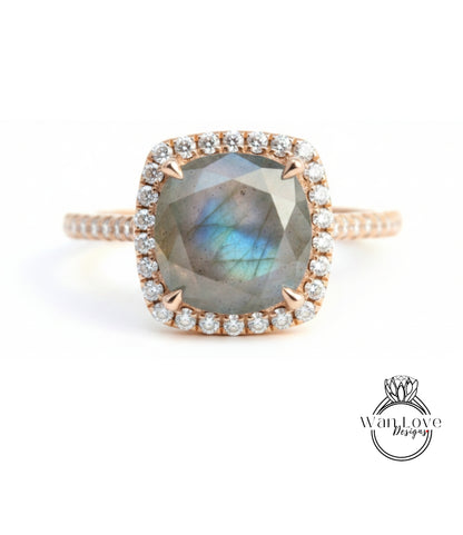 A close-up image of a beautiful engagement ring with a large, square-shaped gemstone surrounded by a halo of smaller diamonds set in a gold band.