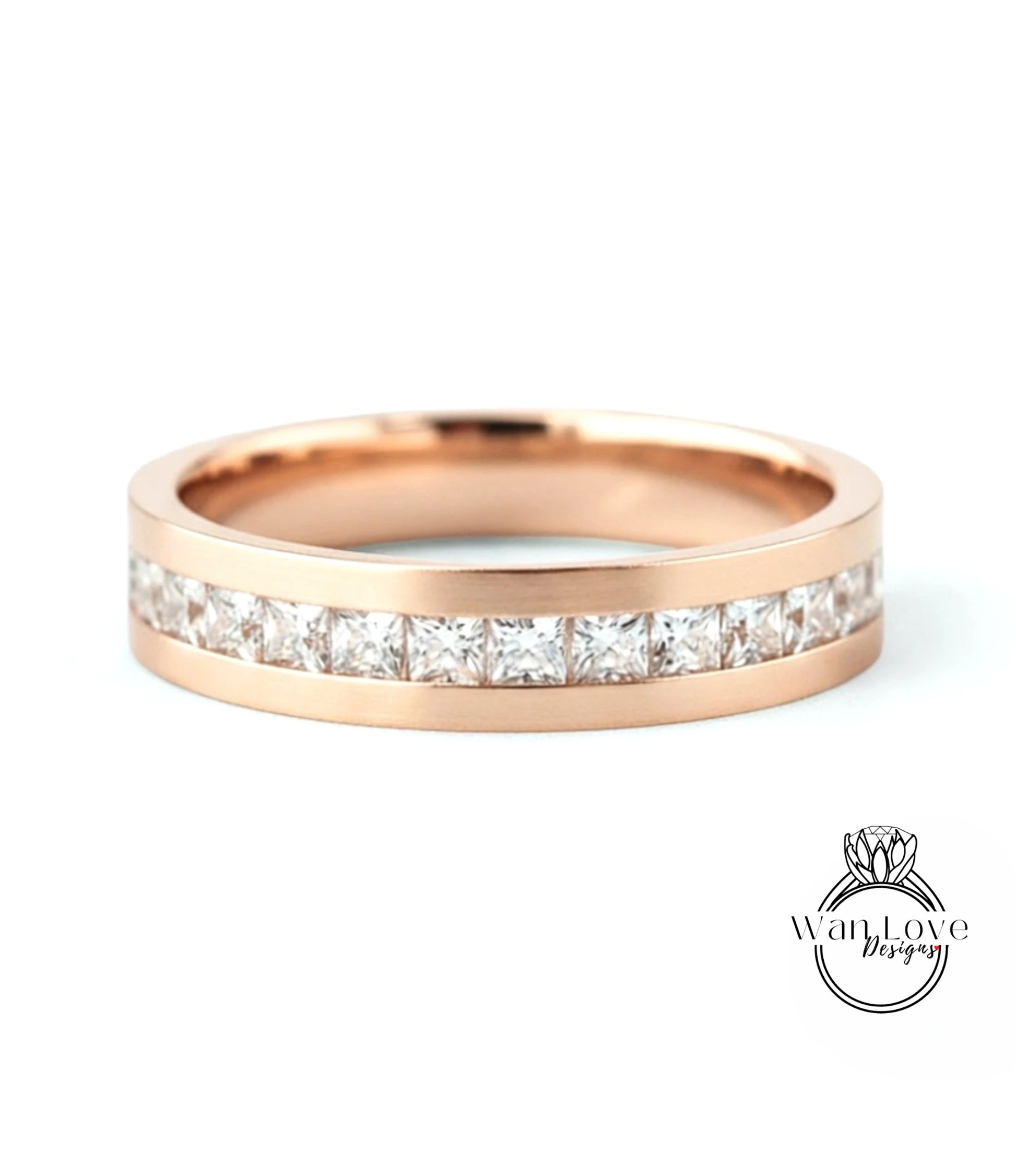 A rose gold band with a row of small diamonds set in the center.