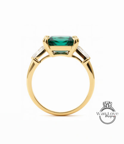 A gold ring with a large, green gemstone set in the center.