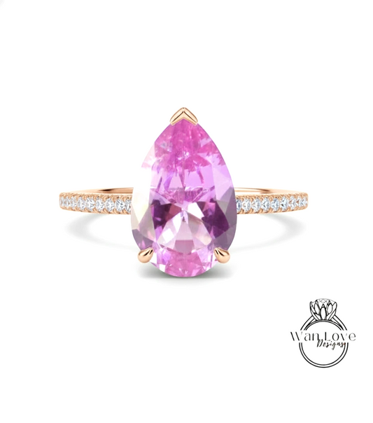 A pink gemstone ring with a gold band and small diamonds.