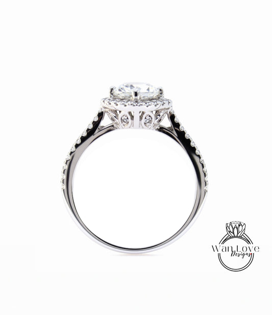 A close-up view of a silver ring with a large central diamond and smaller diamonds around the edge.