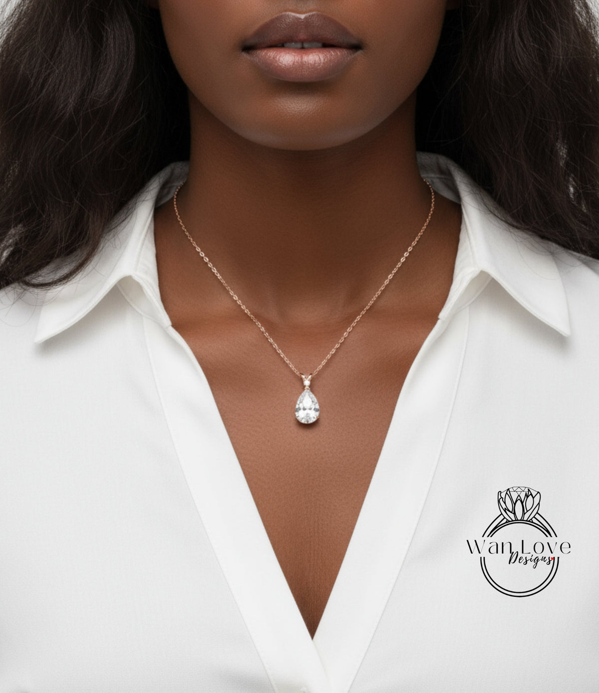 A close-up of a woman wearing a white blouse and a necklace with a large diamond pendant.