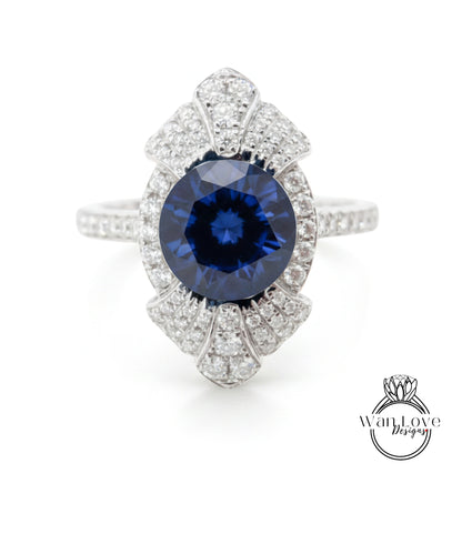 A stunning blue sapphire gemstone set in a silver ring, adorned with numerous sparkling diamonds.
