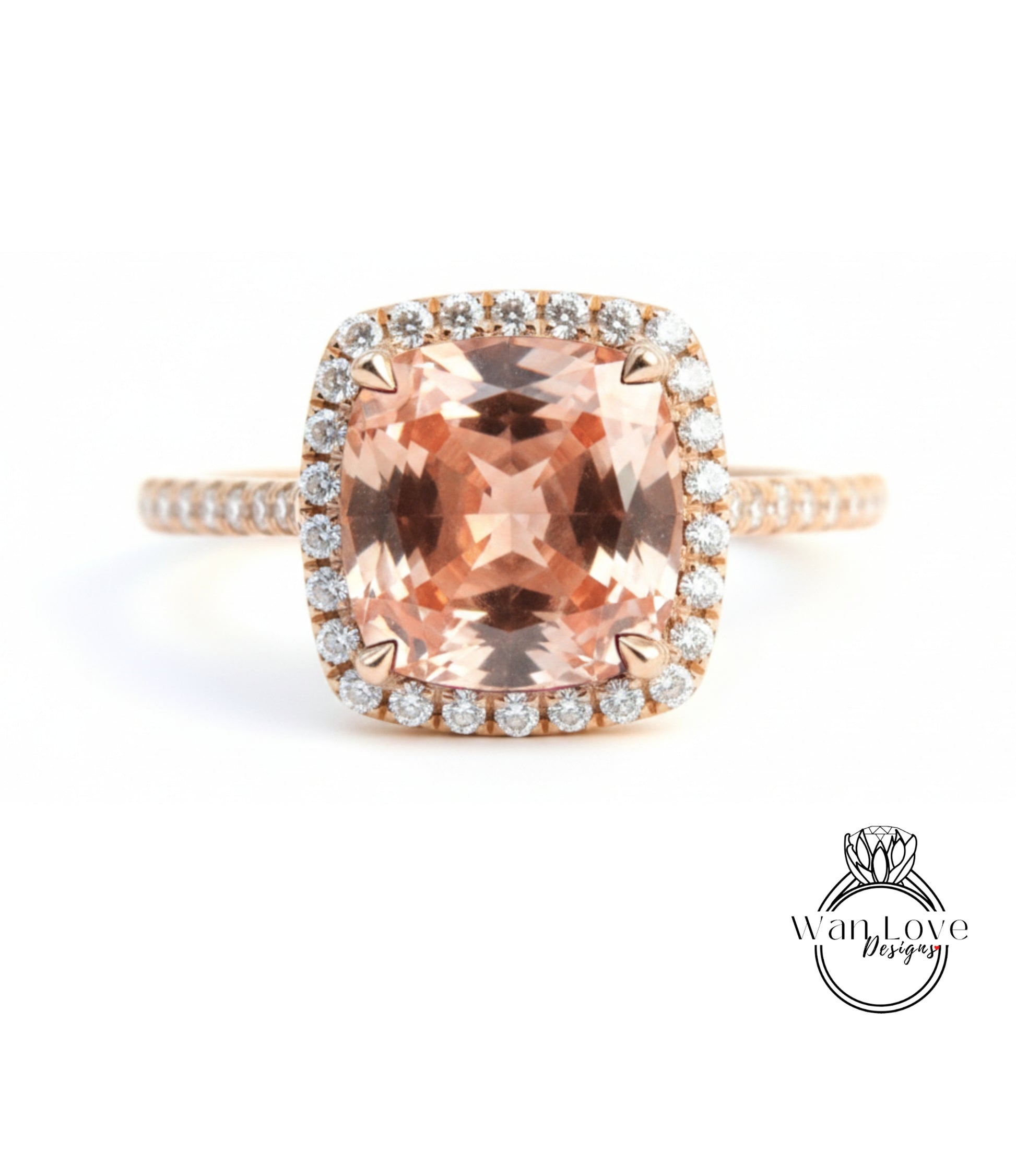 A large, peach-colored gemstone ring with a halo of smaller diamonds around the center stone.