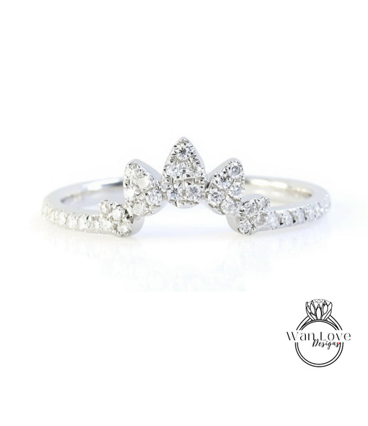 A close-up view of a diamond ring with a large central diamond surrounded by smaller diamonds, set in a silver band.