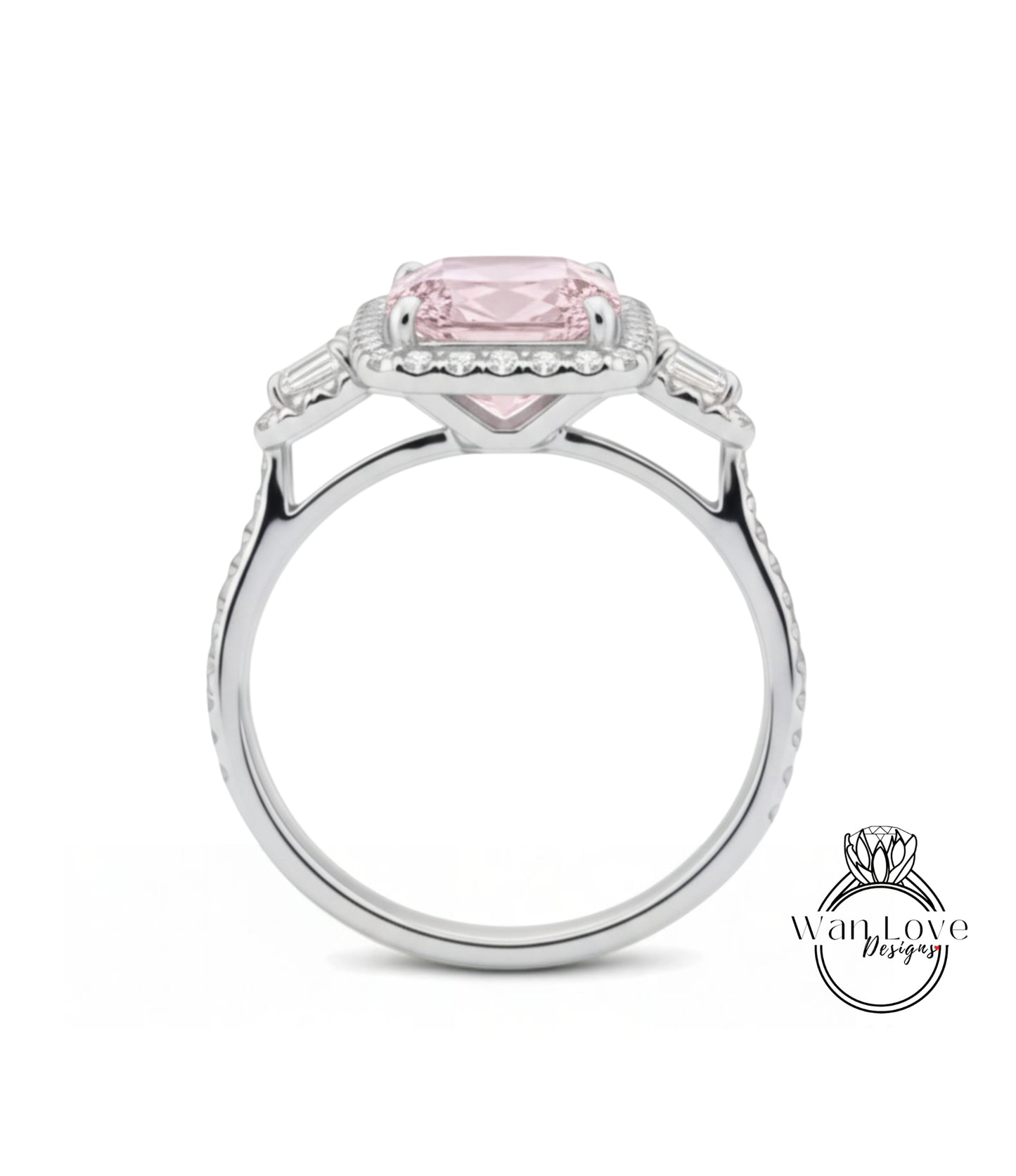 A silver ring with a large pink gemstone, possibly a diamond, set in the center.