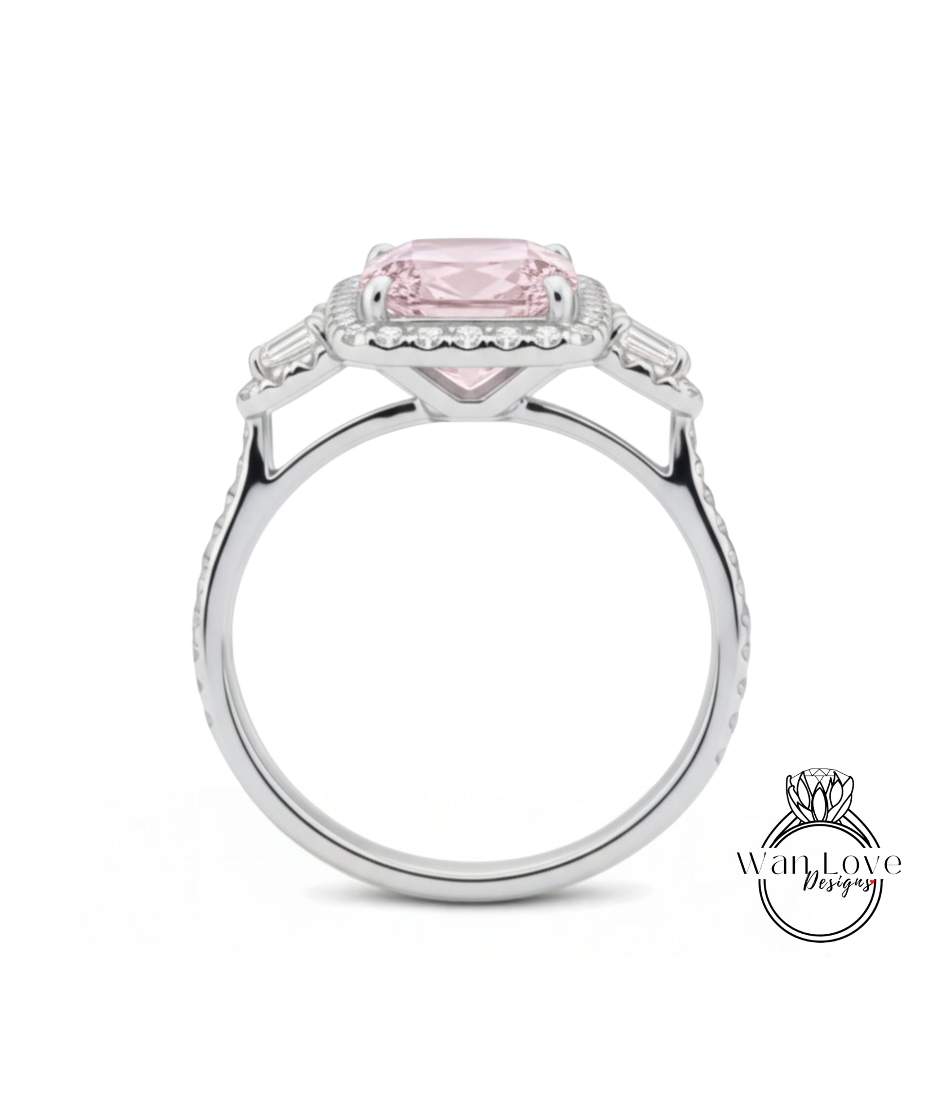A silver ring with a large pink gemstone, possibly a diamond, set in the center.