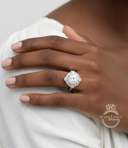 A close-up of a person's hand wearing a large, ornate diamond ring on the ring finger.