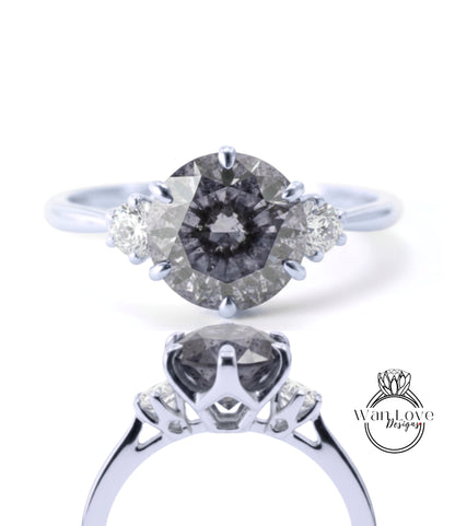 A close-up view of a silver engagement ring with a large oval-shaped diamond as the centerpiece, surrounded by smaller diamonds.